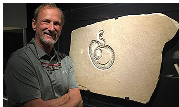 Tom Lindgren with the Green River Snake Fossil